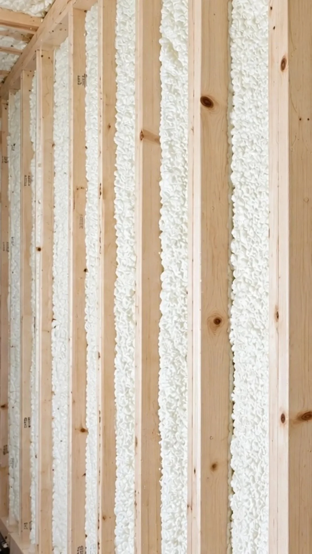 Close-up of wall framing and spray-foam insulation