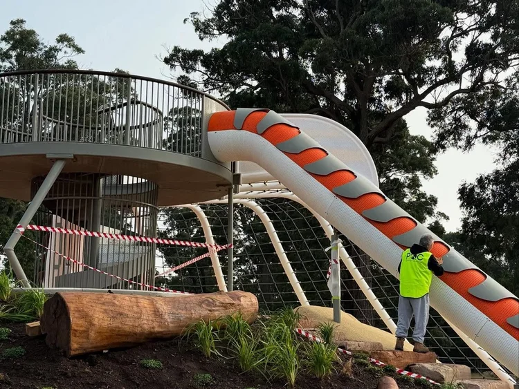 PQC painter working on a playground slide in Appin for the NSW Government
