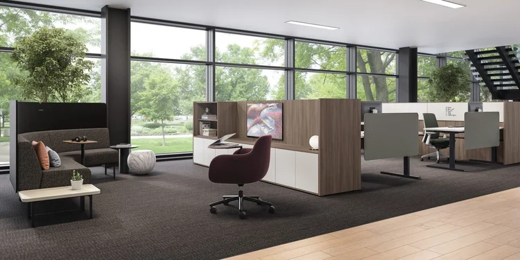 Open office with a high-back lounge booth and a burgundy swivel chair