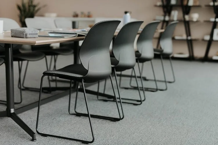 Black sled-base chairs at training tables