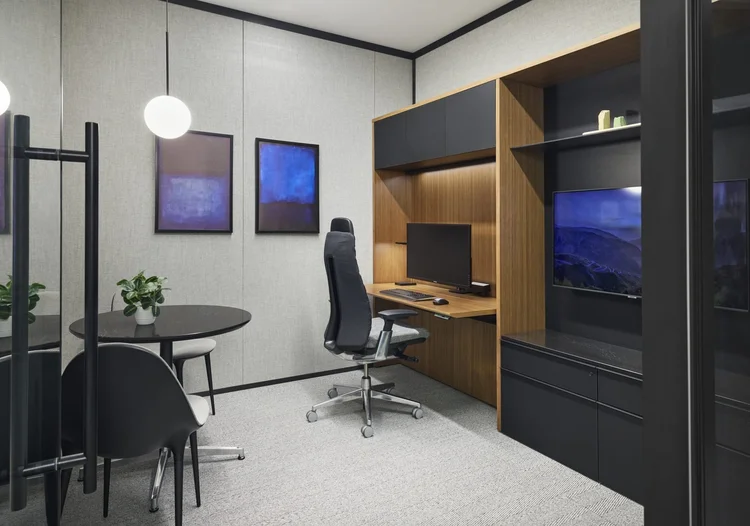 Private office with walnut storage wall and black task chair