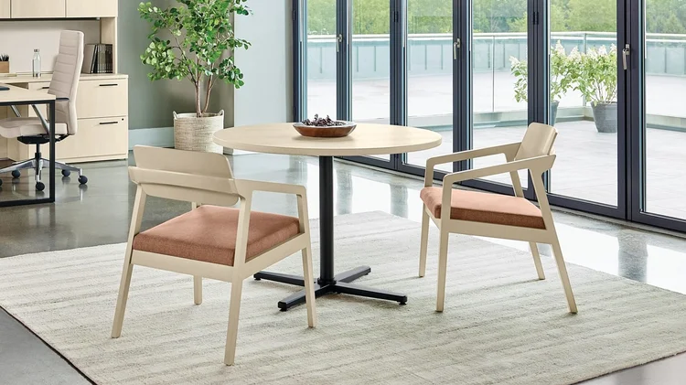 Round cafe table with two upholstered armchairs