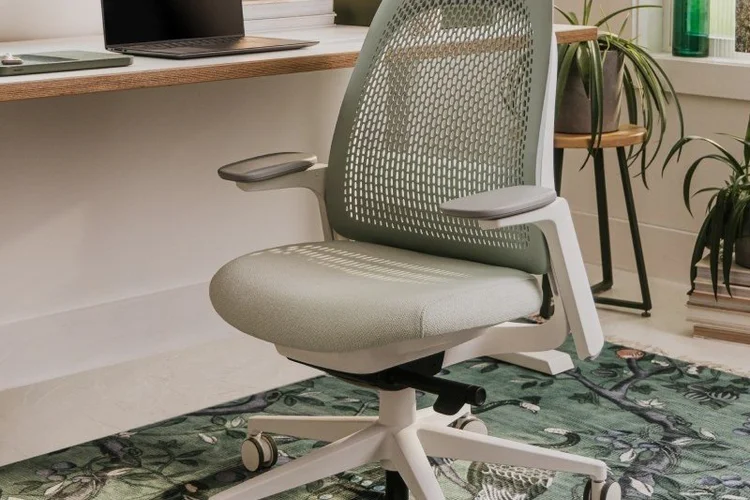 Sage green task chair on a patterned rug
