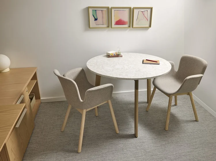 Round marble-top table with two lounge chairs