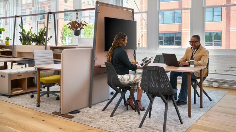 Shared table with a mobile screen and storage pedestals