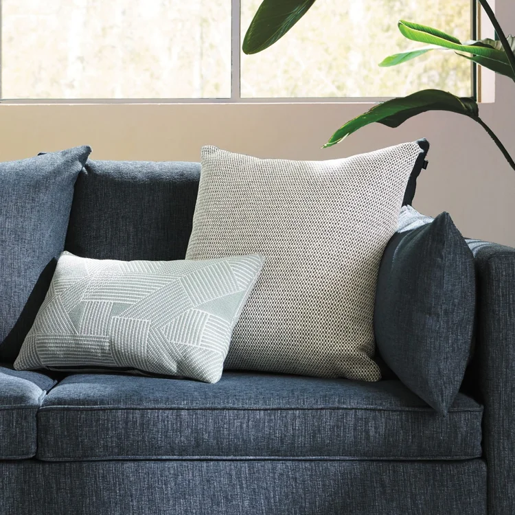 Navy sofa with textured throw pillows
