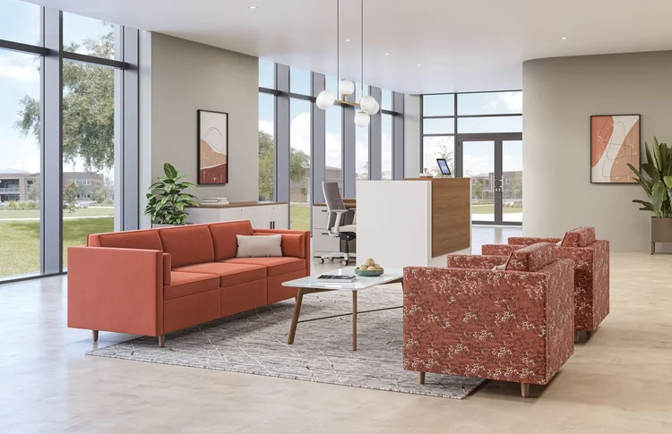 Reception area with an orange sofa and patterned armchairs