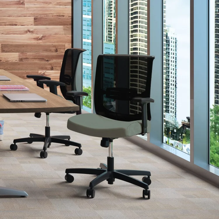 Mesh task chair in a conference room by windows