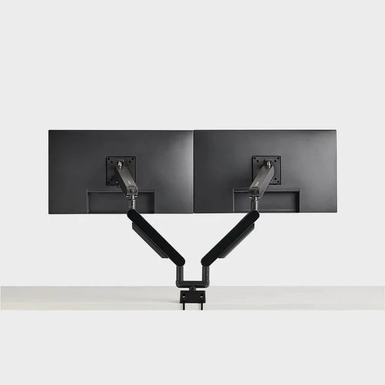 Dual monitor arm mounted on a desk
