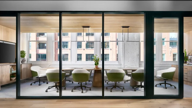 Glass-walled conference room with oval table