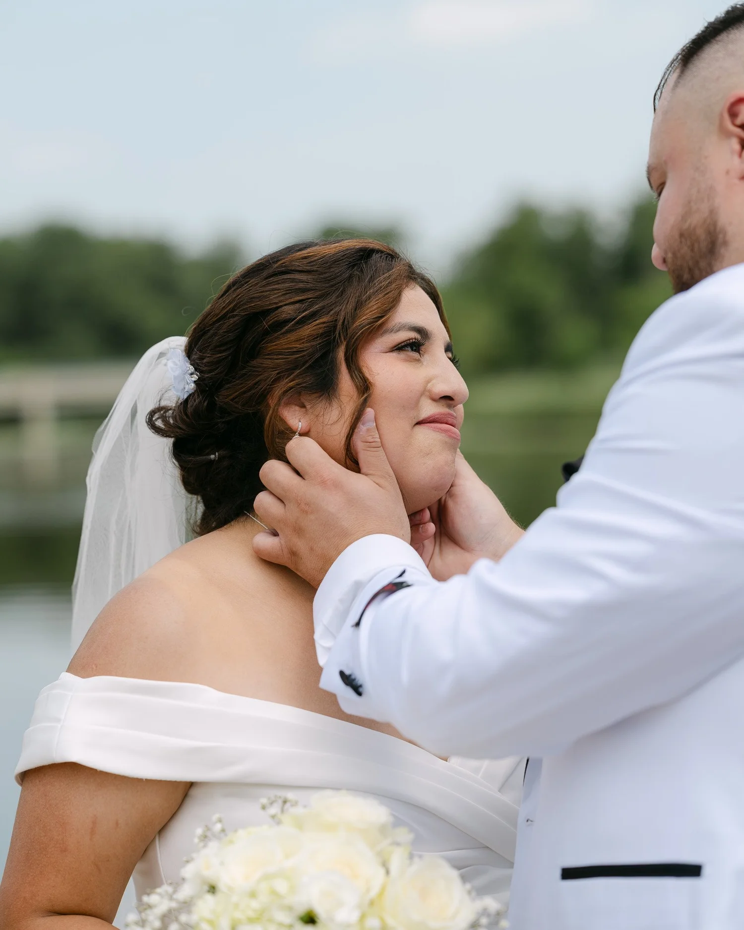 Groom cupping the bride's face