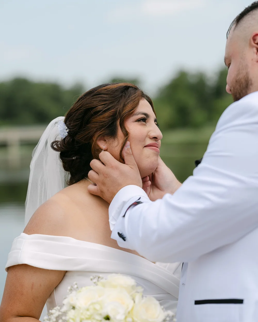 Groom cupping the bride's face