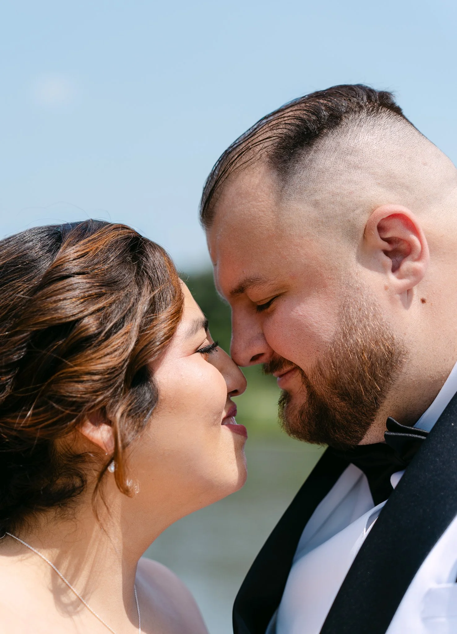 Couple nose to nose by a lake