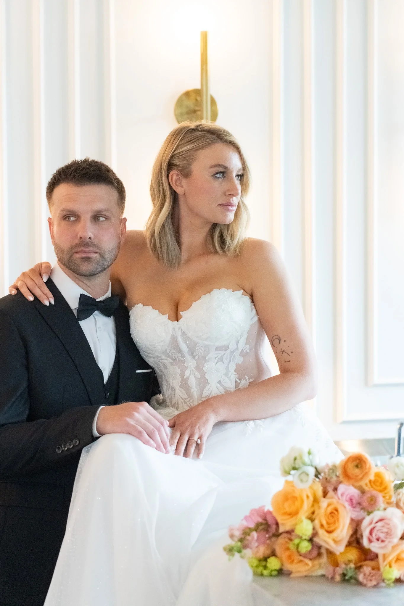 Couple seated with peach florals