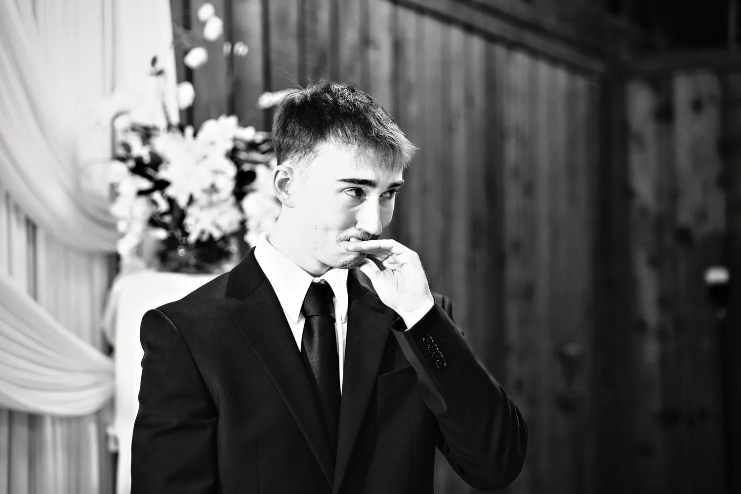 Groom overcome with emotion during the ceremony, black and white