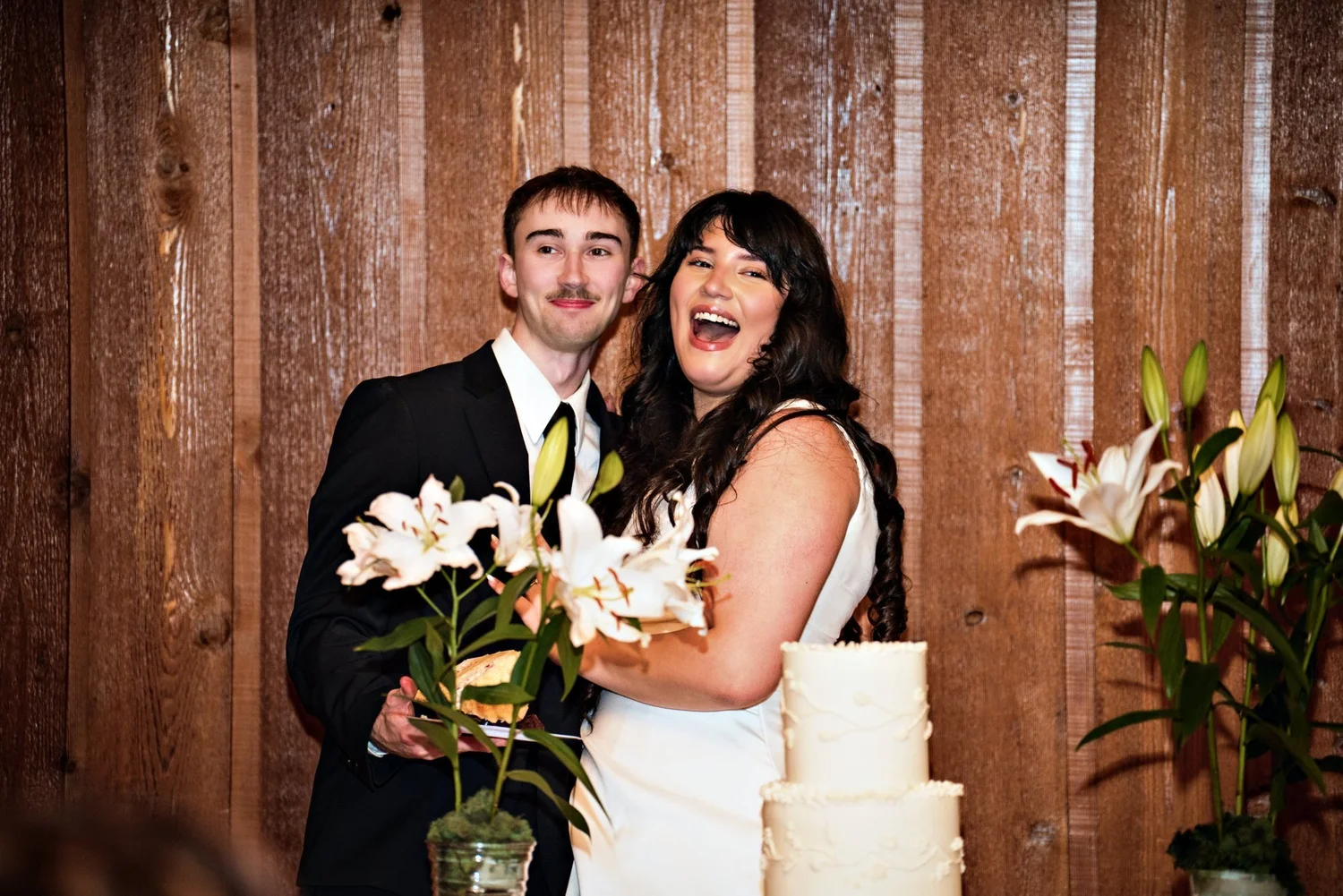 Couple laughing at the cake cutting