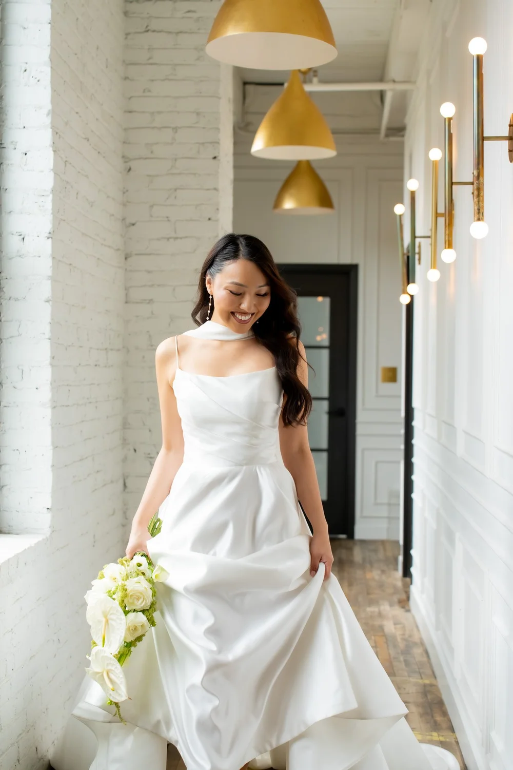 Bride walking down a white hallway
