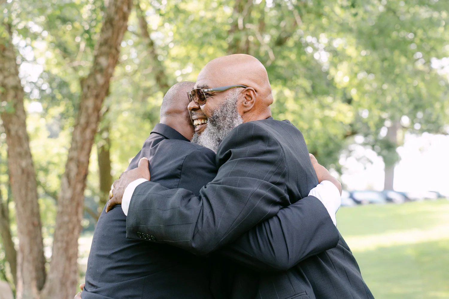 Father of the bride hugging the groom