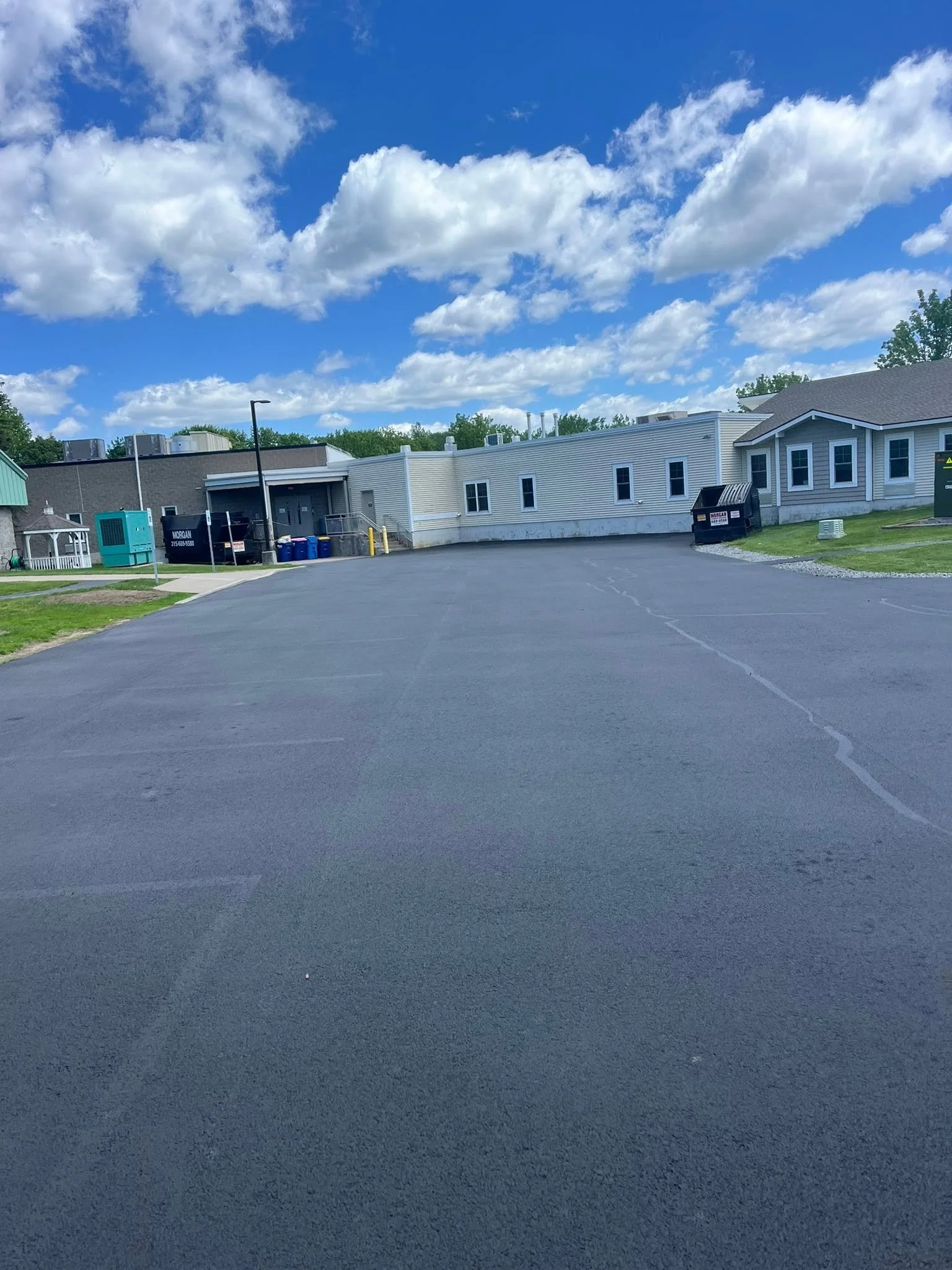 Freshly sealed lot behind a commercial building