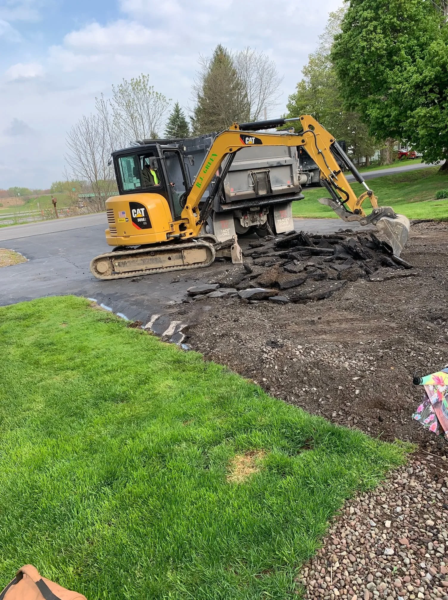 Excavator preparing a driveway base