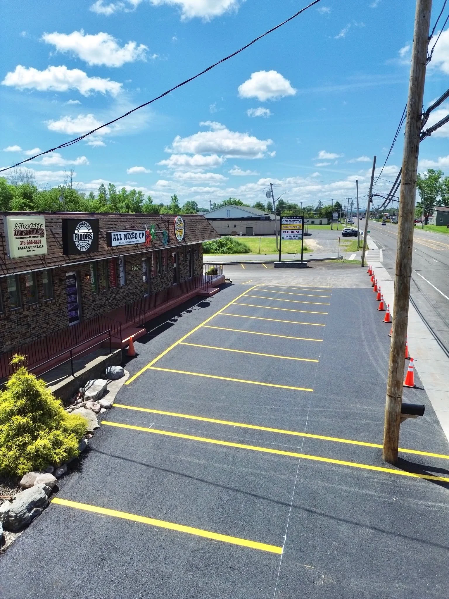 Aerial view of a newly paved and striped plaza parking lot