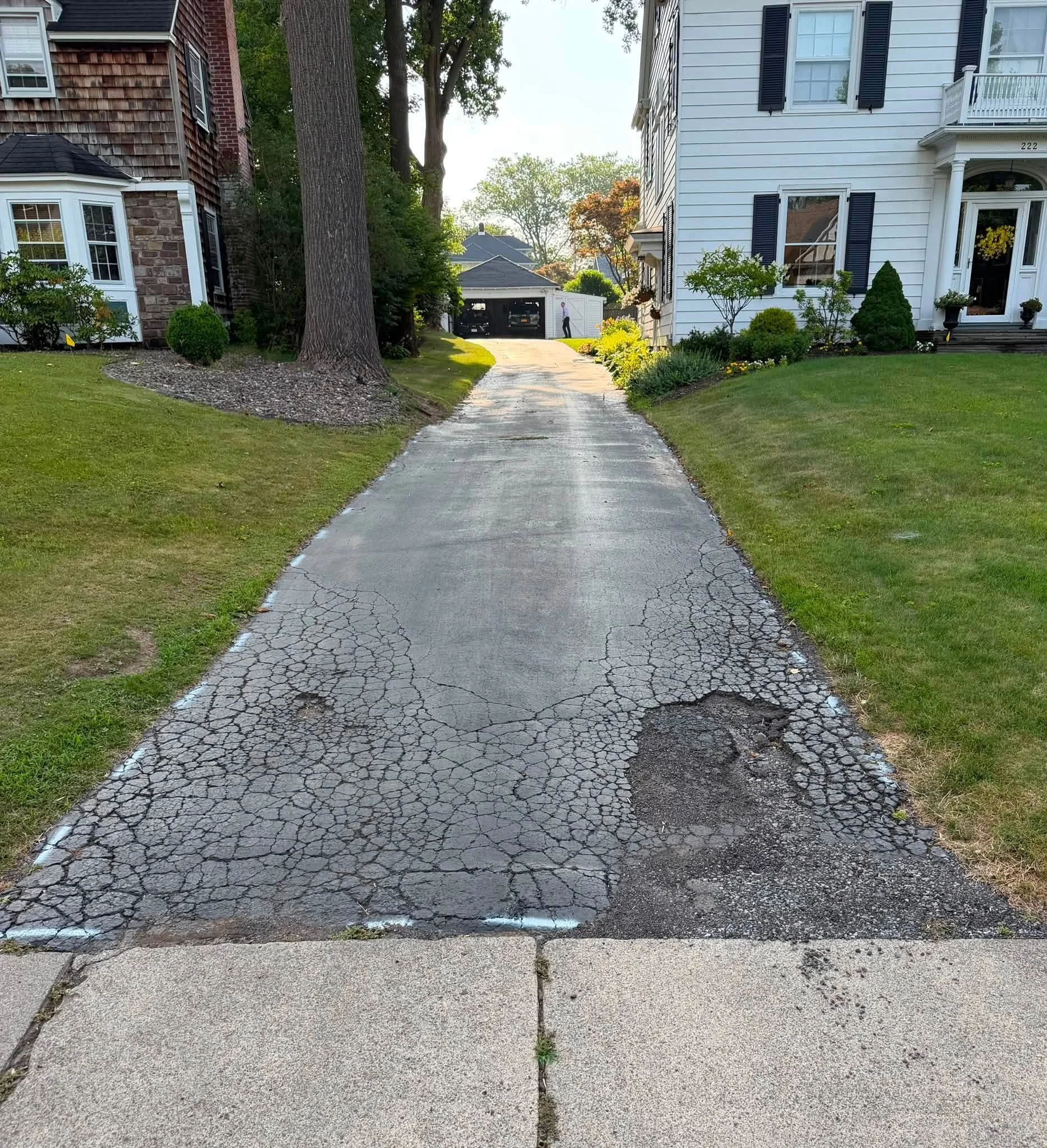 Cracked asphalt driveway before paving