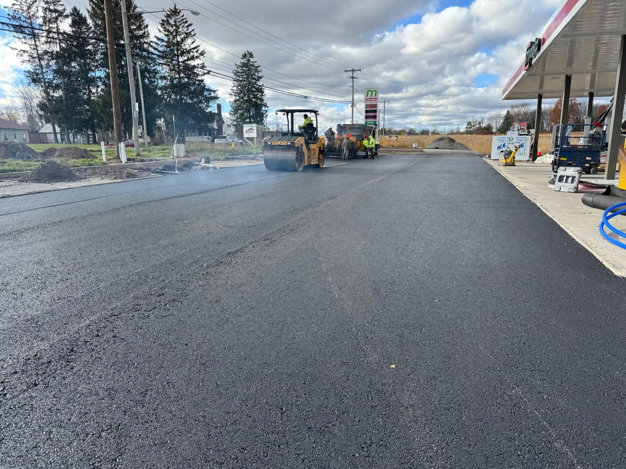 RJ Green crew paving and rolling a gas station lot