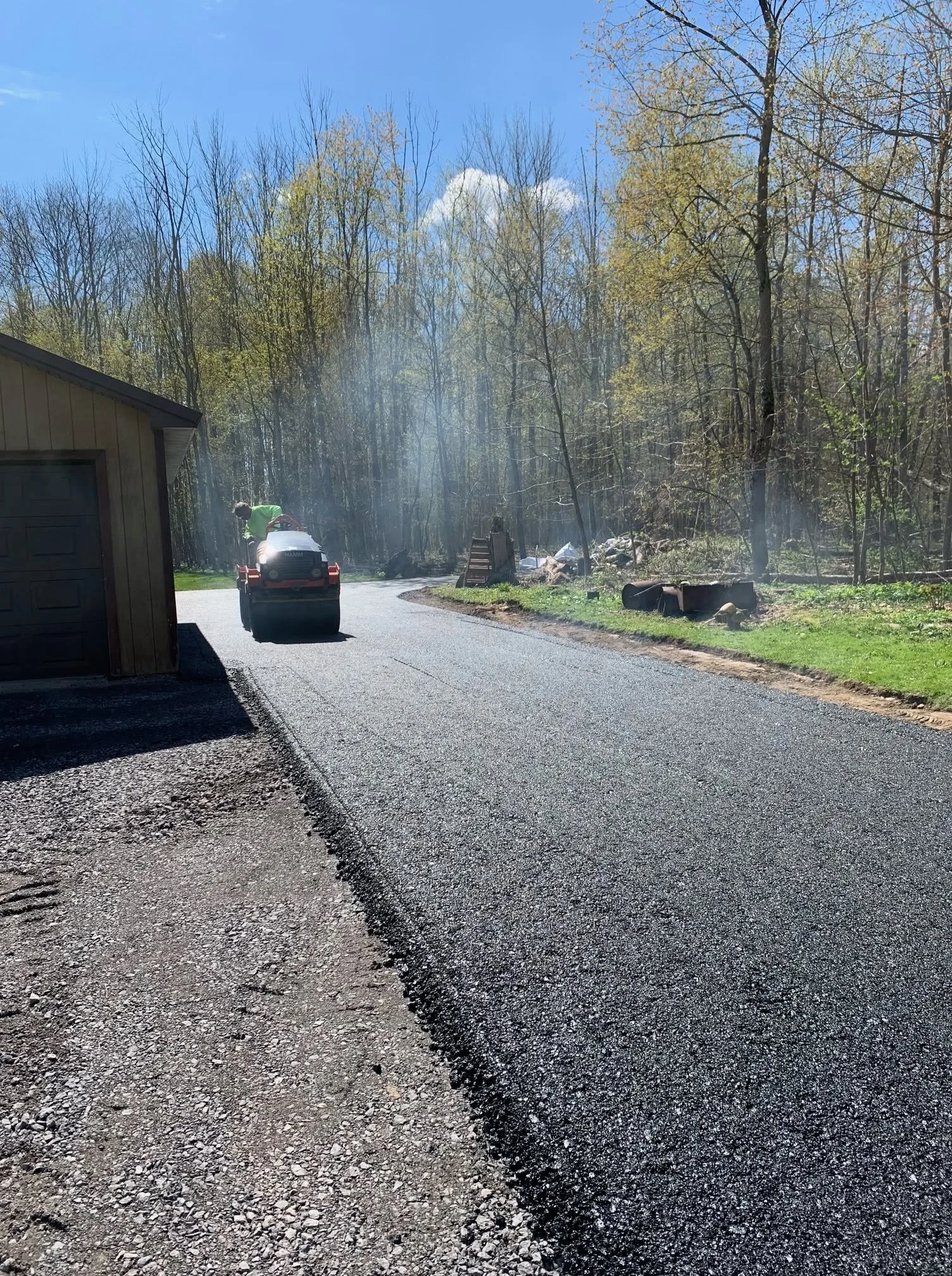 RJ Green roller compacting a new driveway
