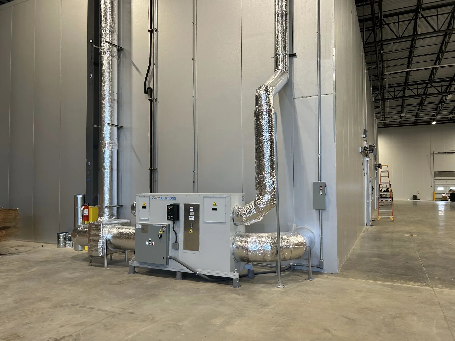 Refrigeration equipment and ductwork beside a large chamber