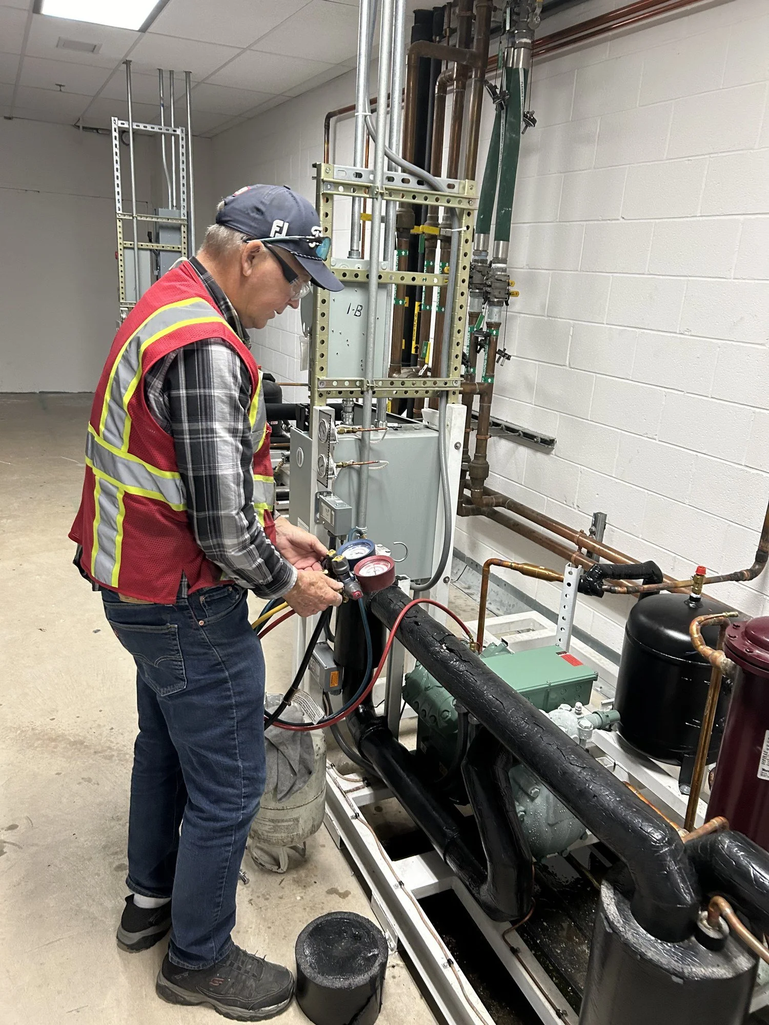 Airflow technician servicing refrigeration equipment