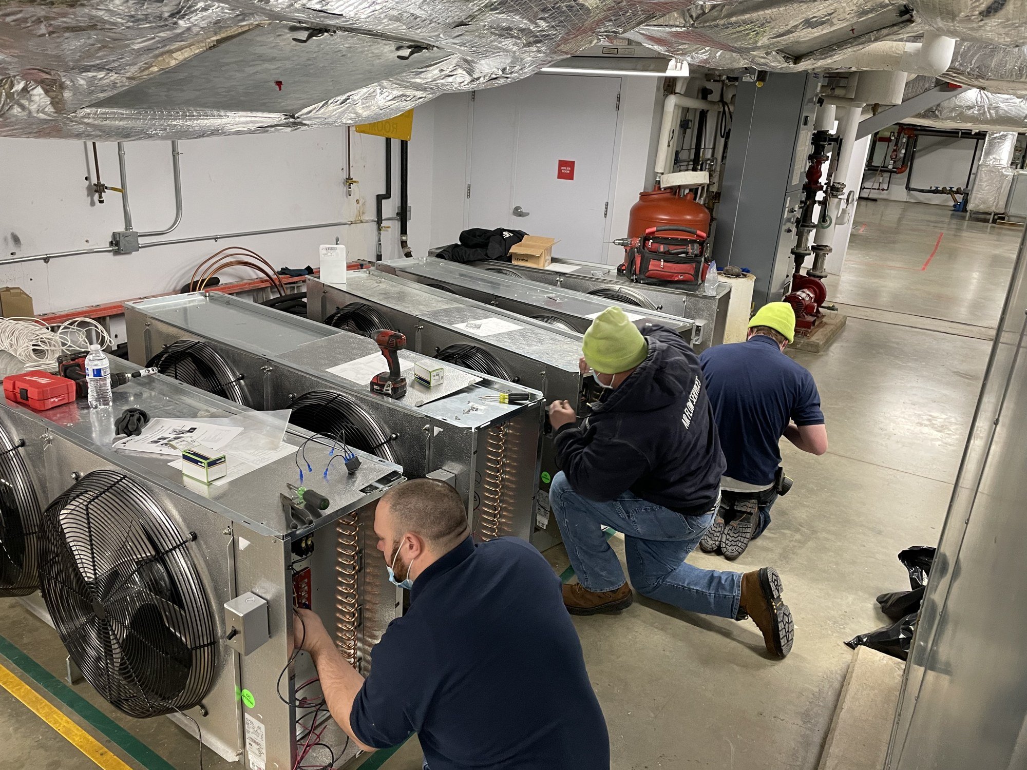Airflow team working together on commercial refrigeration equipment