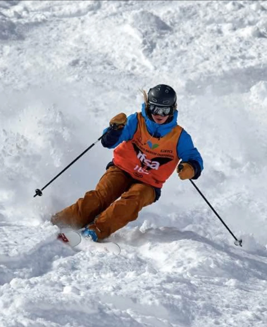 Scout skiing a steep line, from her big mountain competition days