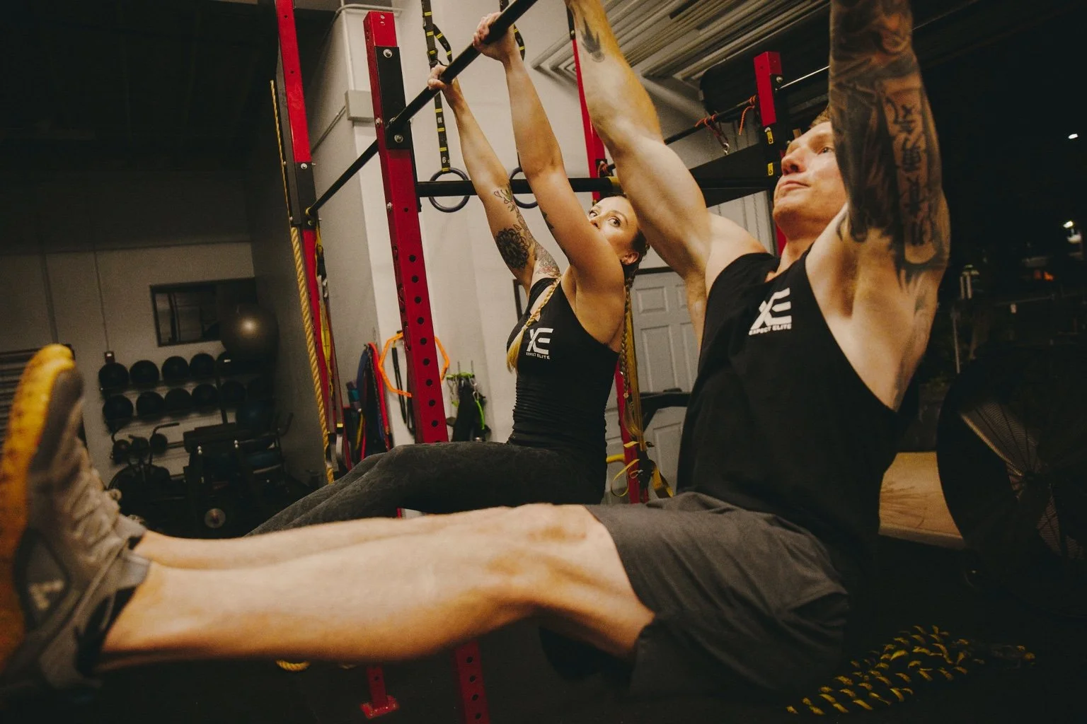 Daniel and Jana performing hanging leg raises together