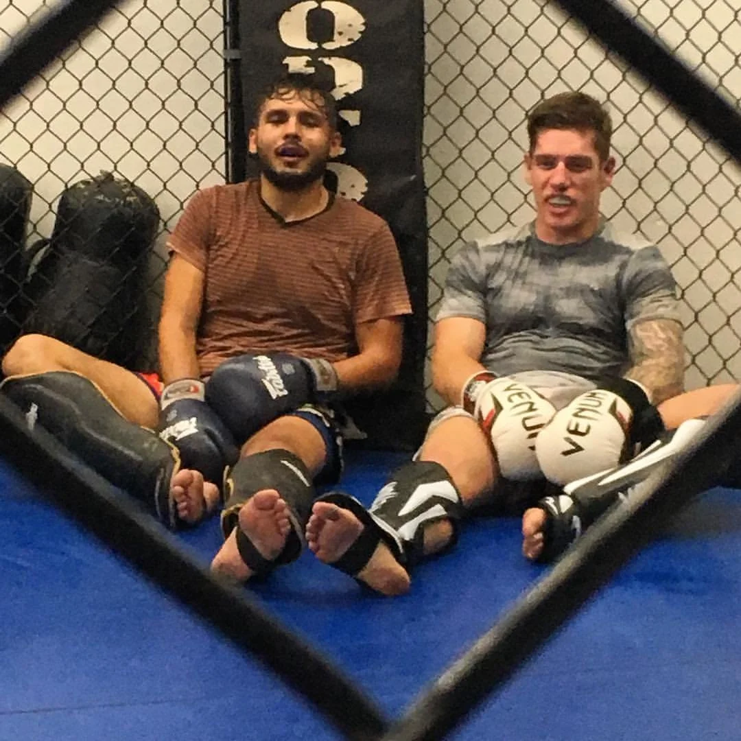 Daniel resting with a training partner after sparring