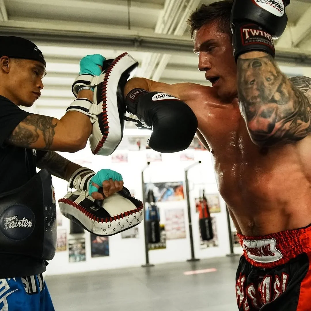 Daniel practicing an elbow strike with his pad holder