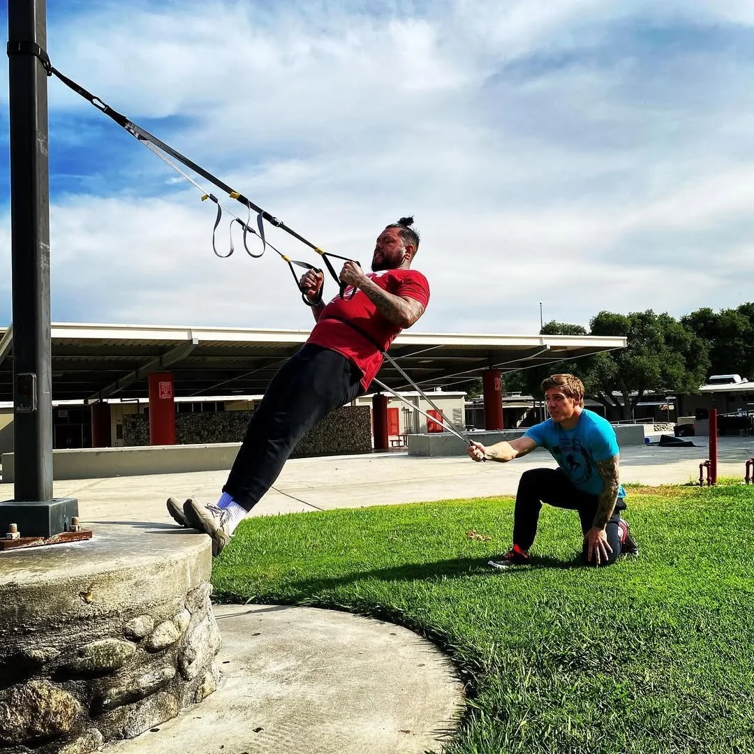 Daniel coaching a suspension row outdoors