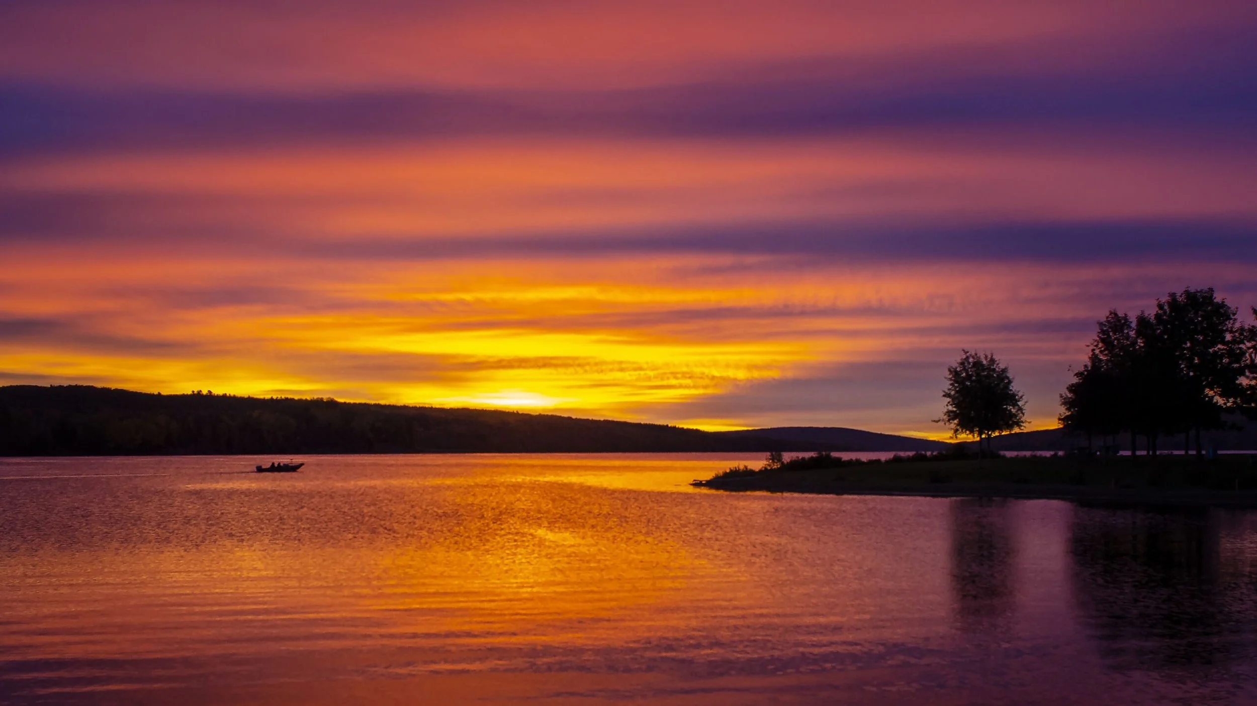 Fishing boat on a lake at sunrise