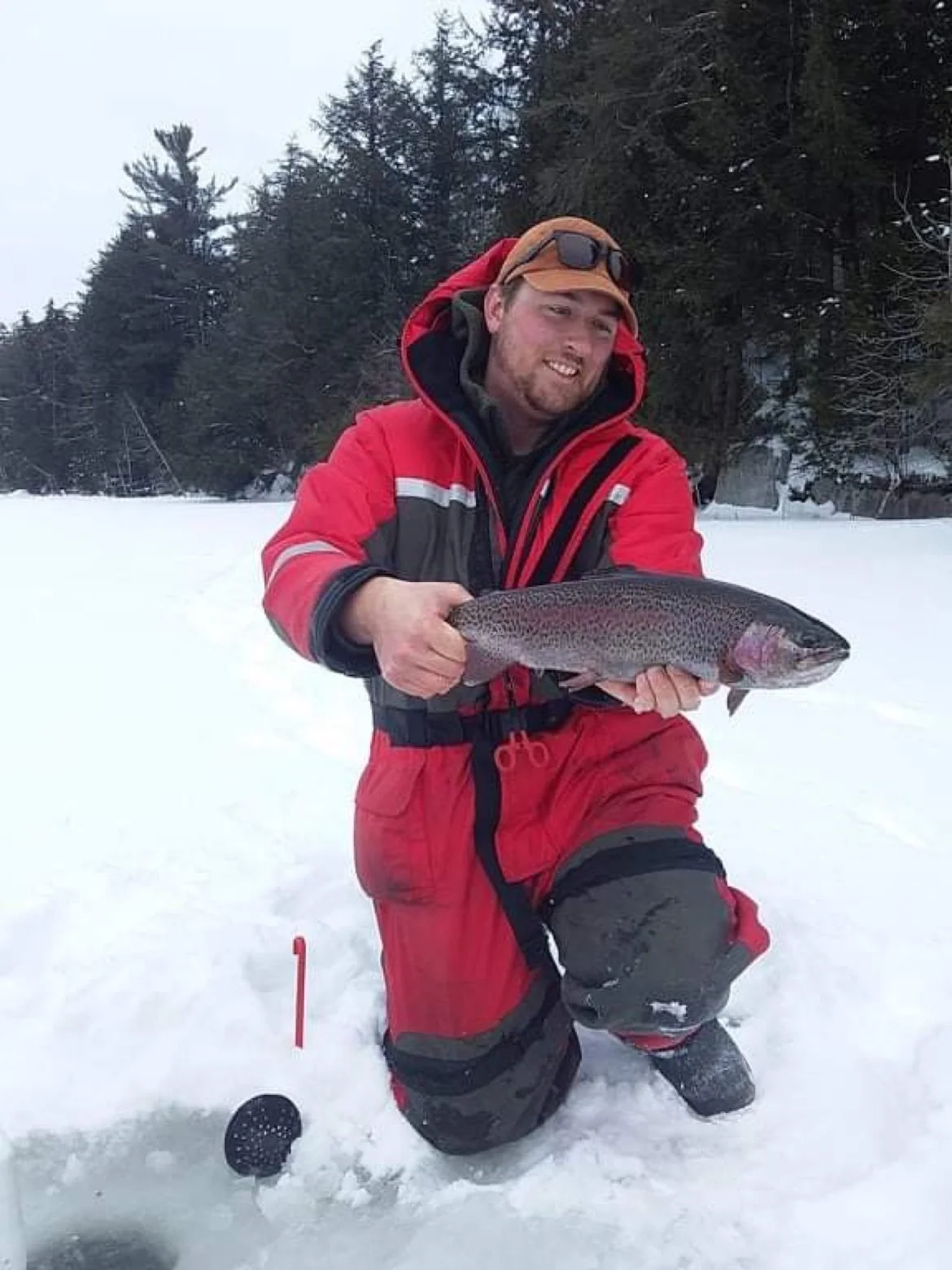 Chris Saunders holding a tip-up caught Rainbow Trout