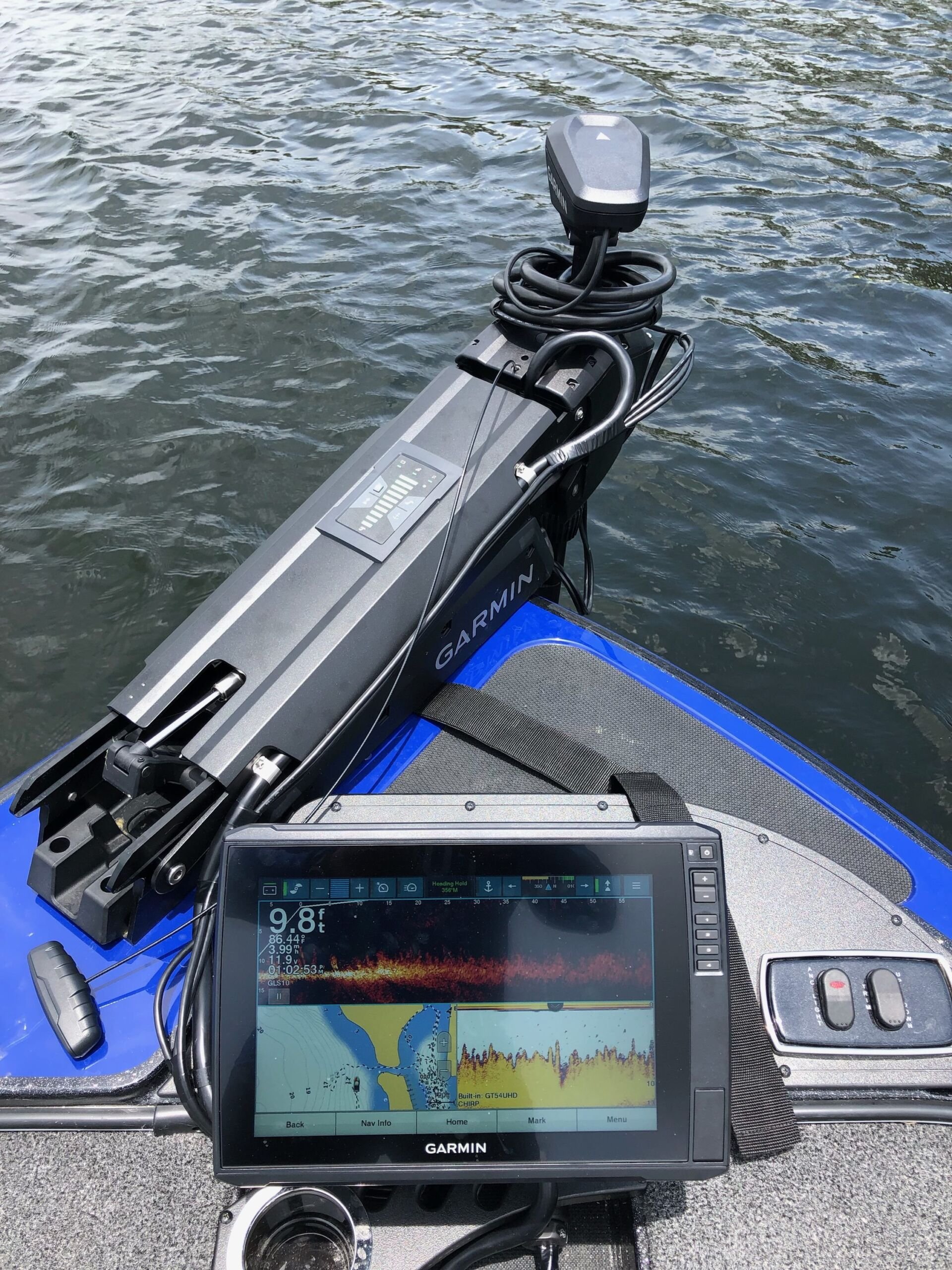 An electric trolling motor beside a Garmin fishfinder