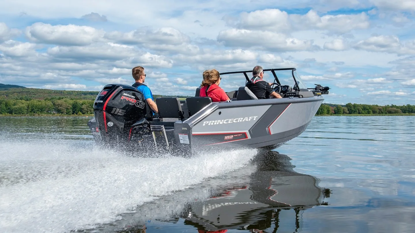 A Princecraft boat driving down a lake
