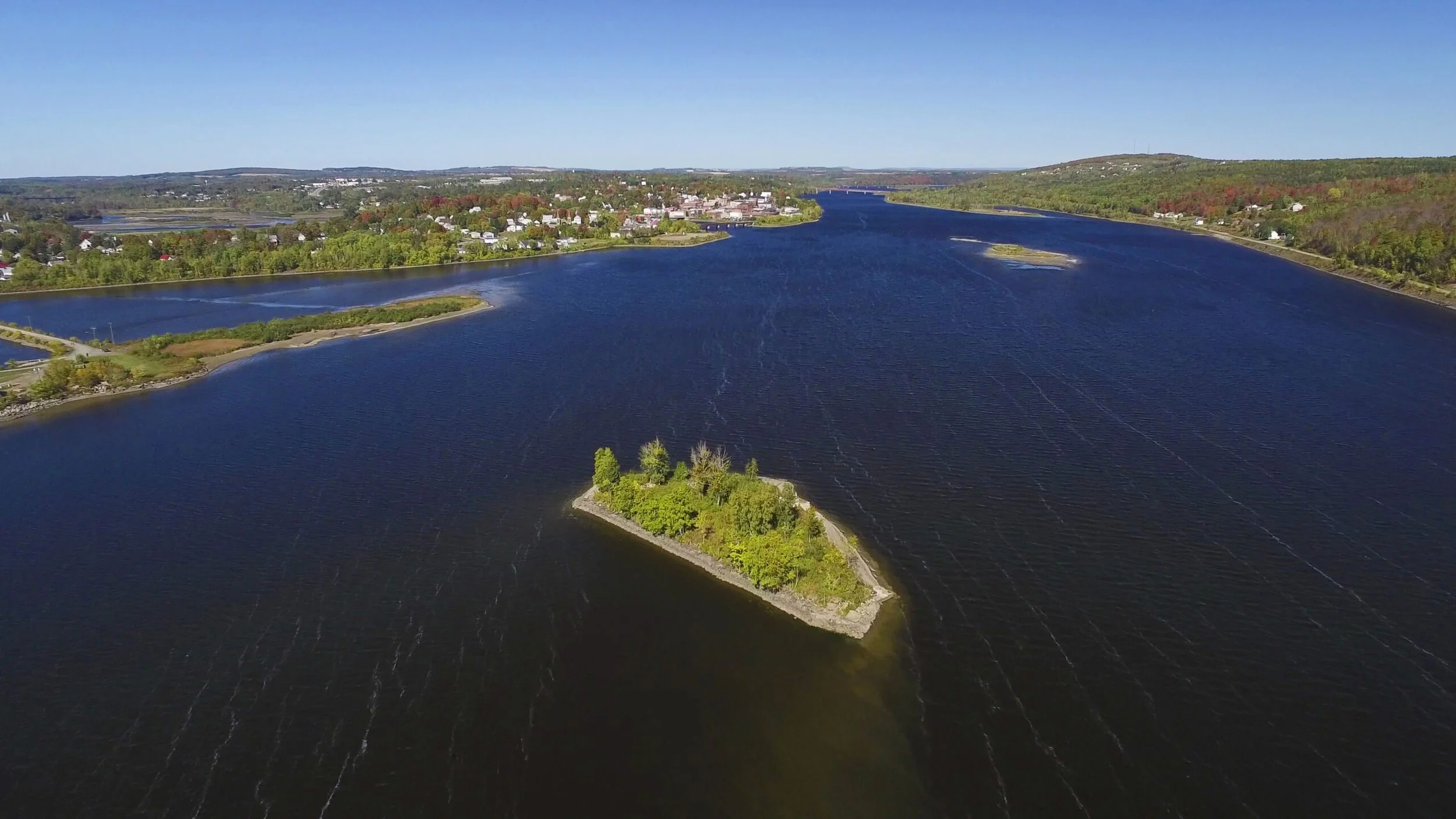 Aerial view of a lake and wooded island