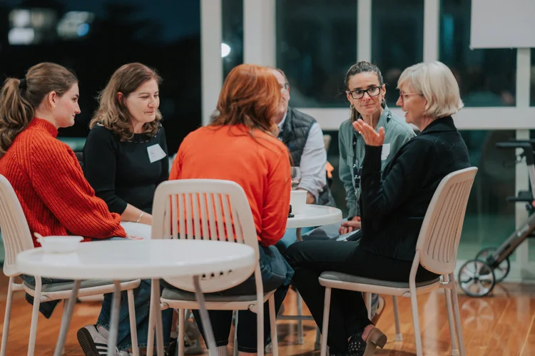 Women talking together around a table at Alpha.