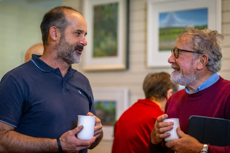 Two men chatting over mugs at St Philip’s.