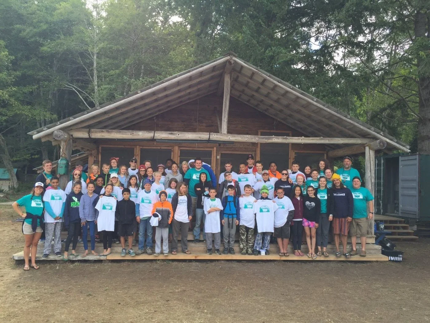 The first session of campers and staff back at Camp in 2016, gathered on the steps of a lodge