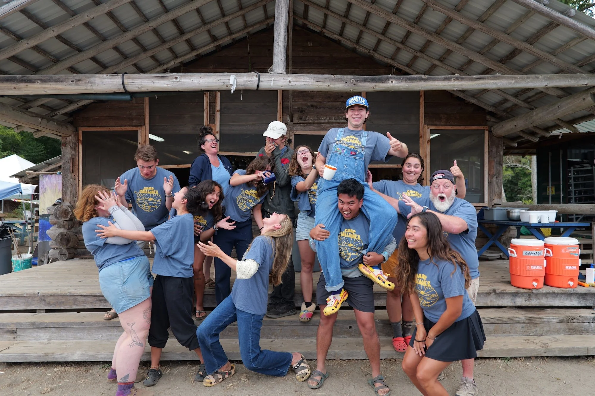 Camp staff in matching shirts striking playful poses