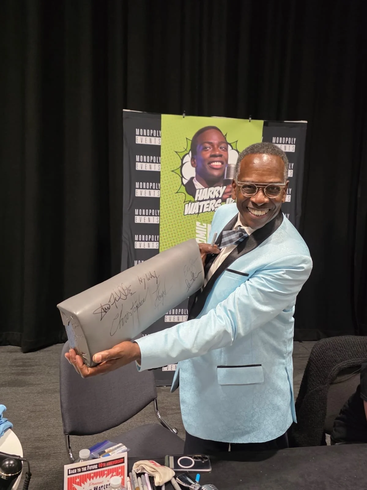 Harry Waters Jr holding the signed time machine knee pad