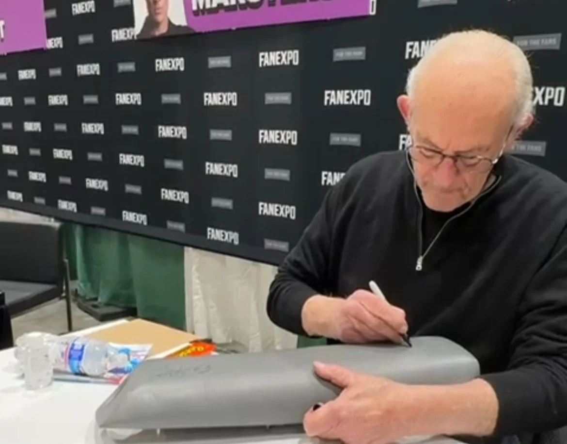 Christopher Lloyd signing the time machine knee pad