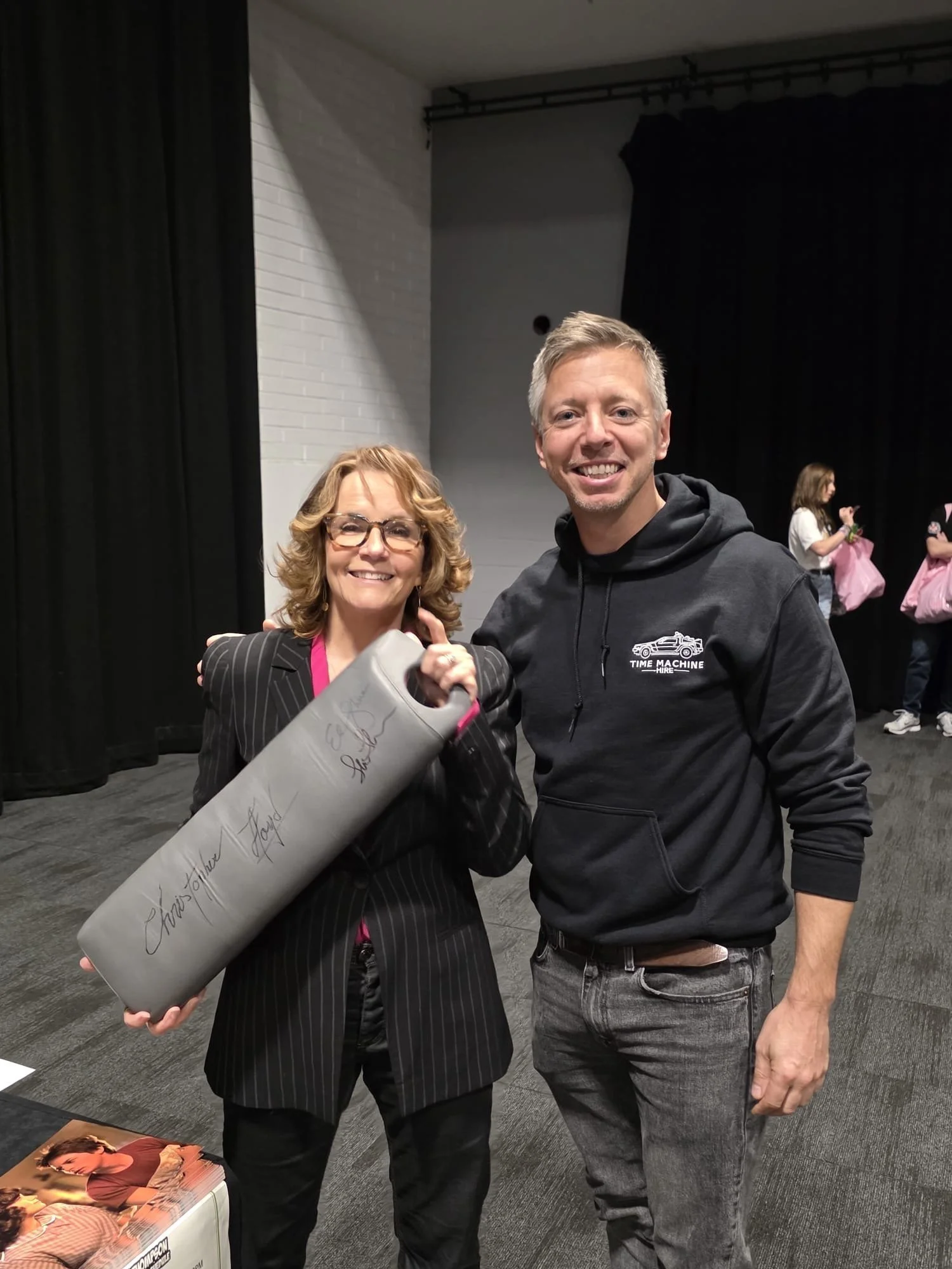 Lea Thompson holding the signed time machine knee pad