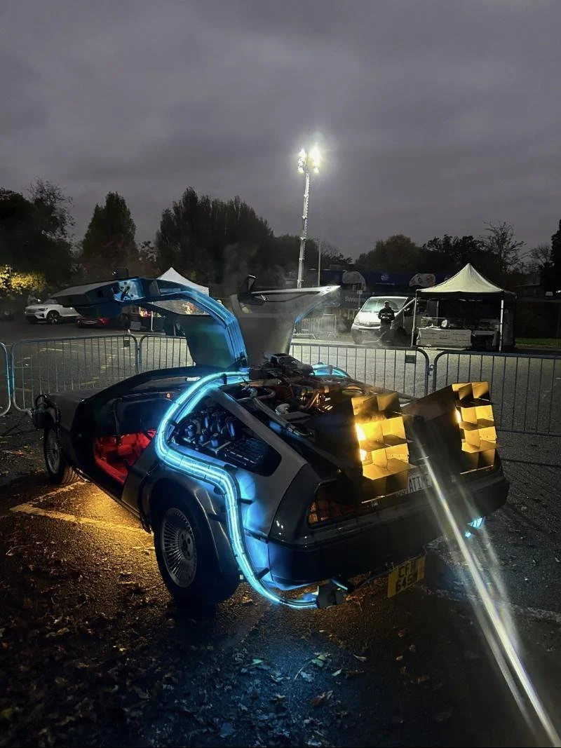 Rear of the time machine glowing blue at night