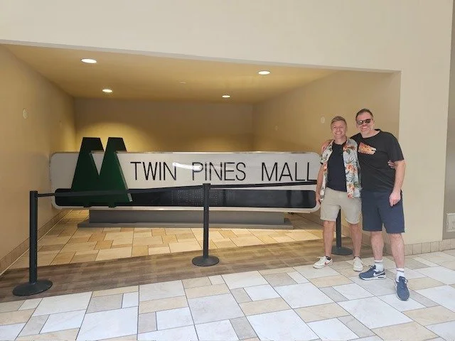 Nick and a friend at the Twin Pines Mall sign